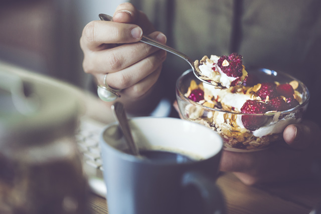 Person eating cereal they got from their breakfast dresser