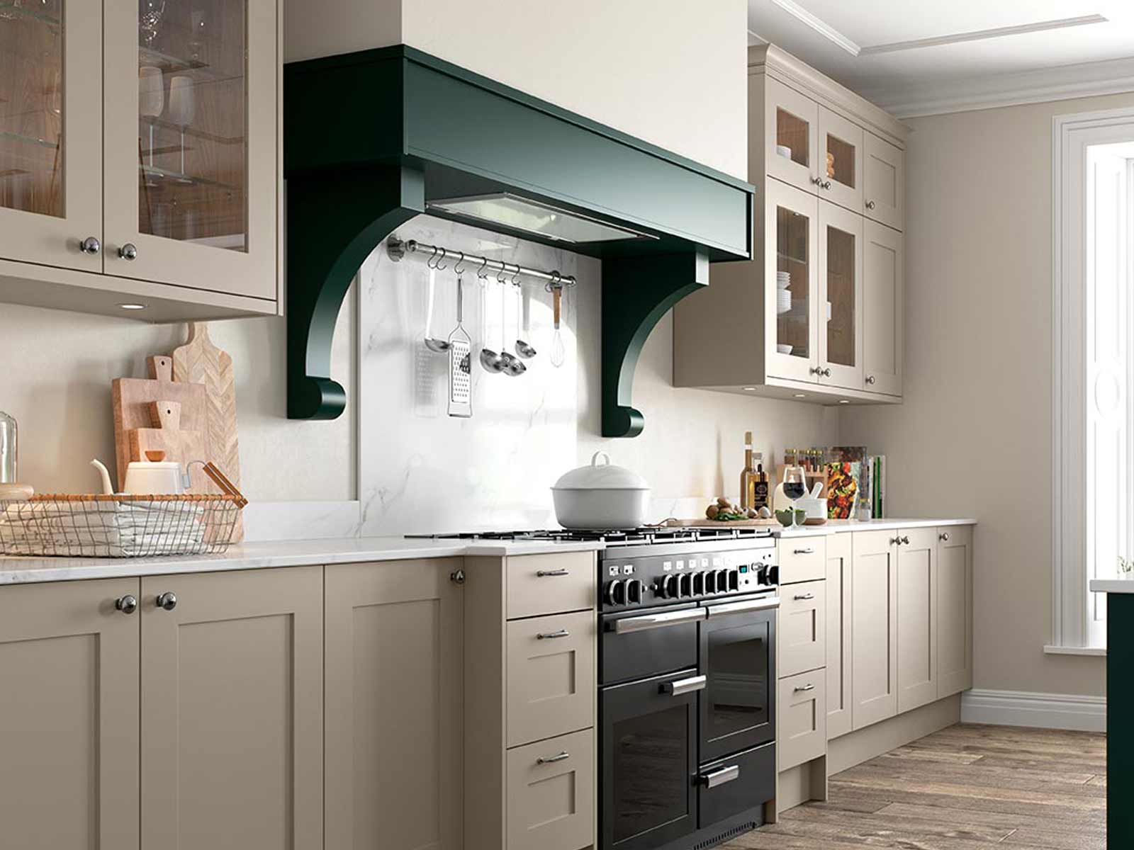 Pale green shaker kitchen with double oven and hood